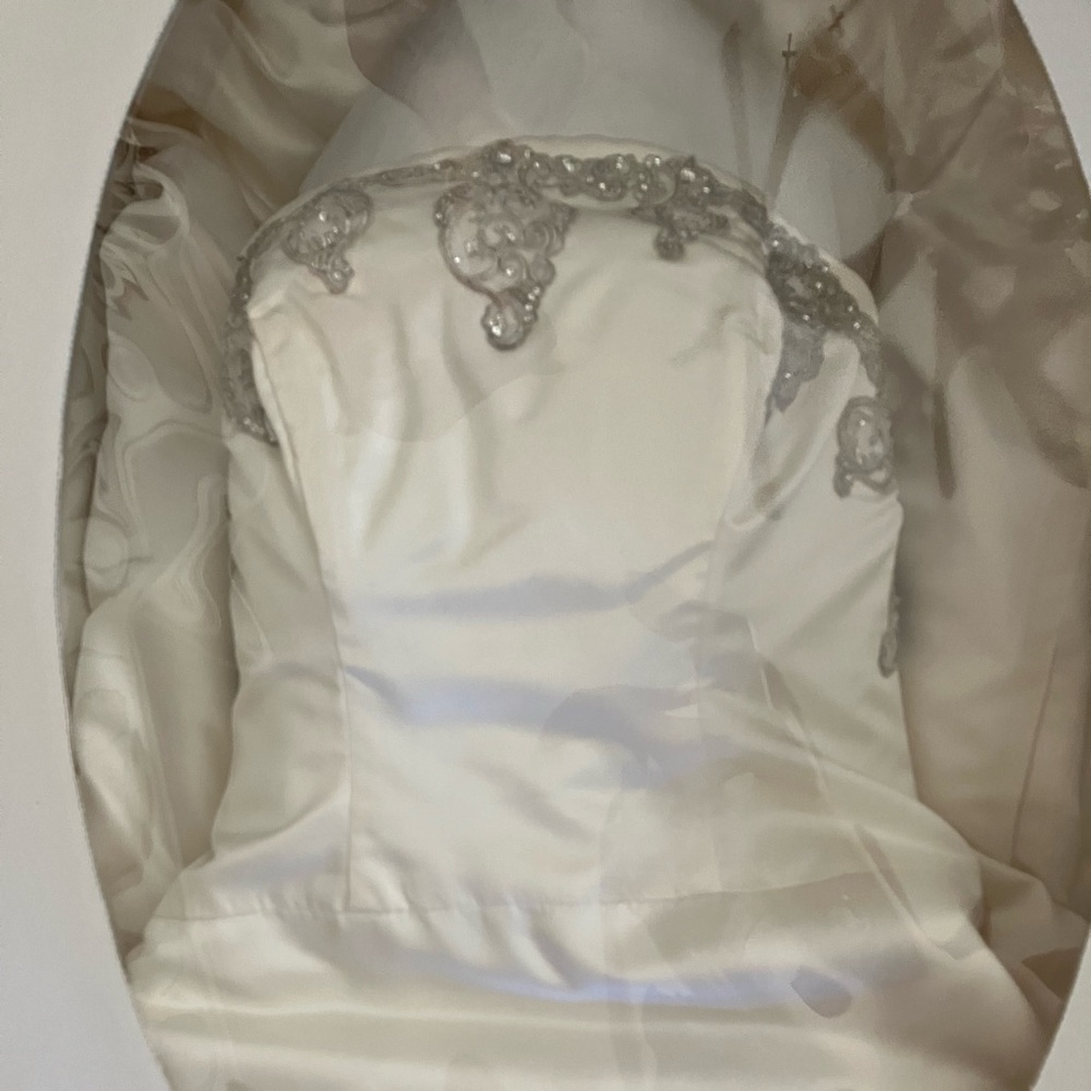 Size 12, hand-beaded wedding gown. Worn once and in a preservation box.